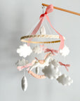 Mobile with a white rocking horse and a pink bow