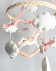 Mobile with a white rocking horse and a pink bow
