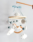 Mobile with a white rocking horse and a blue bow