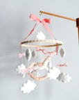 Mobile with a white rocking horse and a pink bow