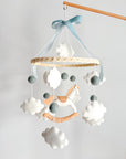 Mobile with a white rocking horse and a blue bow