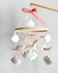 Mobile with a white rocking horse and a pink bow
