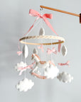 Mobile with a white rocking horse and a pink bow