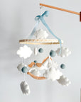 Mobile with a white rocking horse and a blue bow