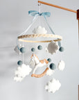 Mobile with a white rocking horse and a blue bow