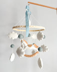 Mobile with a white rocking horse and a blue bow