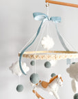 Mobile with a white rocking horse and a blue bow