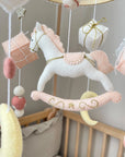 White rocking horse mobile with gifts