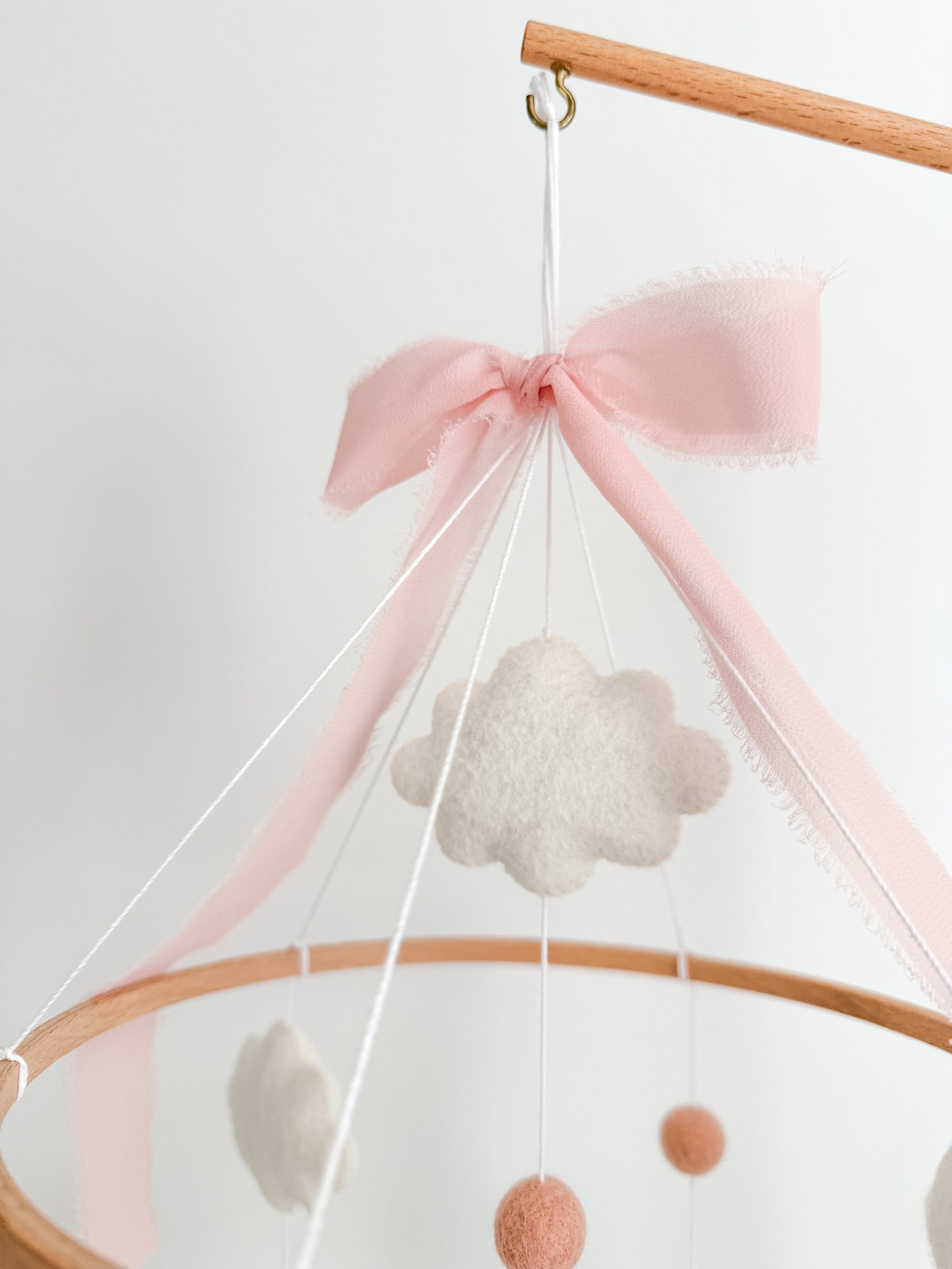 Mobile with a brown rocking horse and pink bow