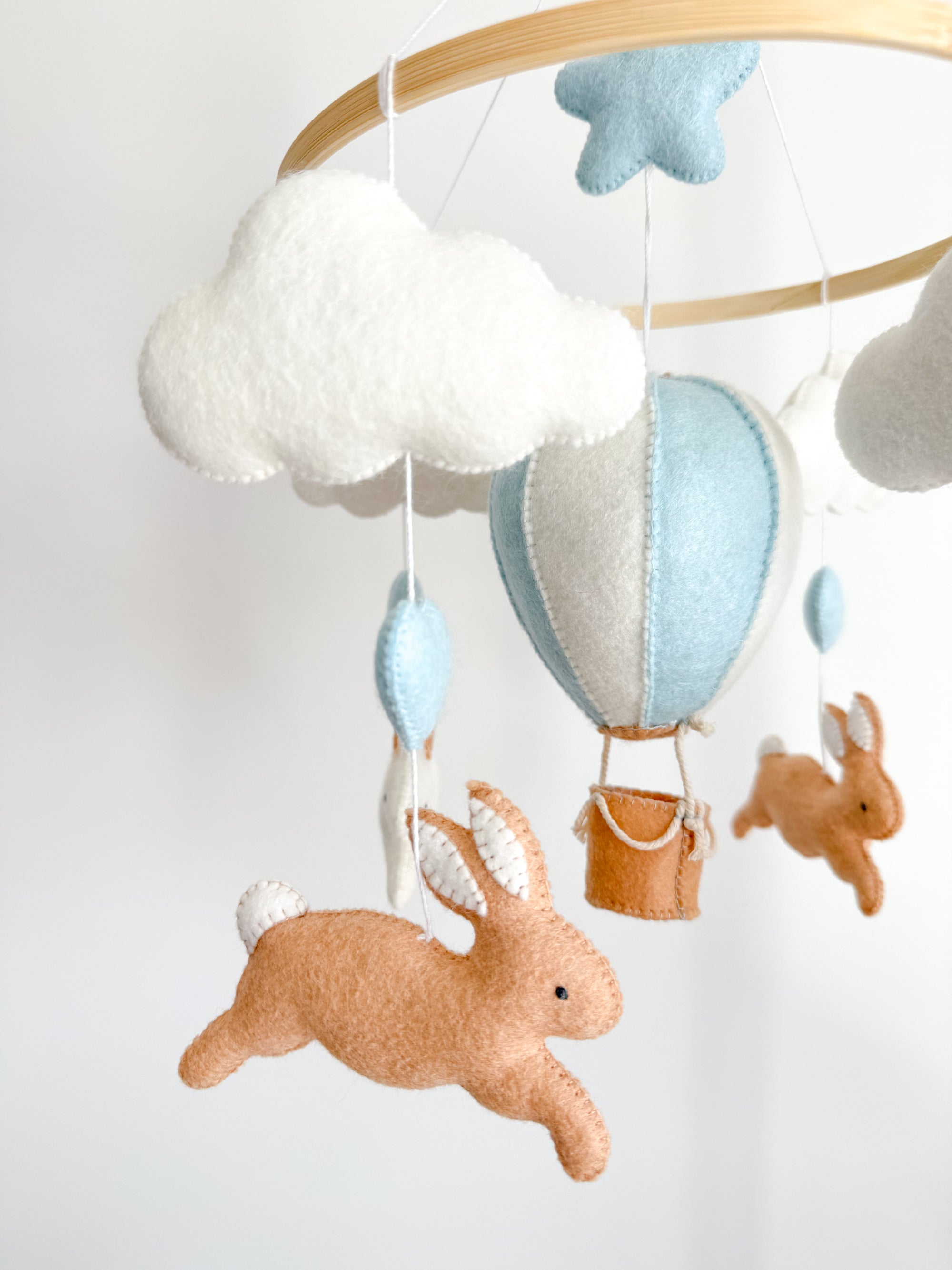 Brown bunny mobile with blue air ballon