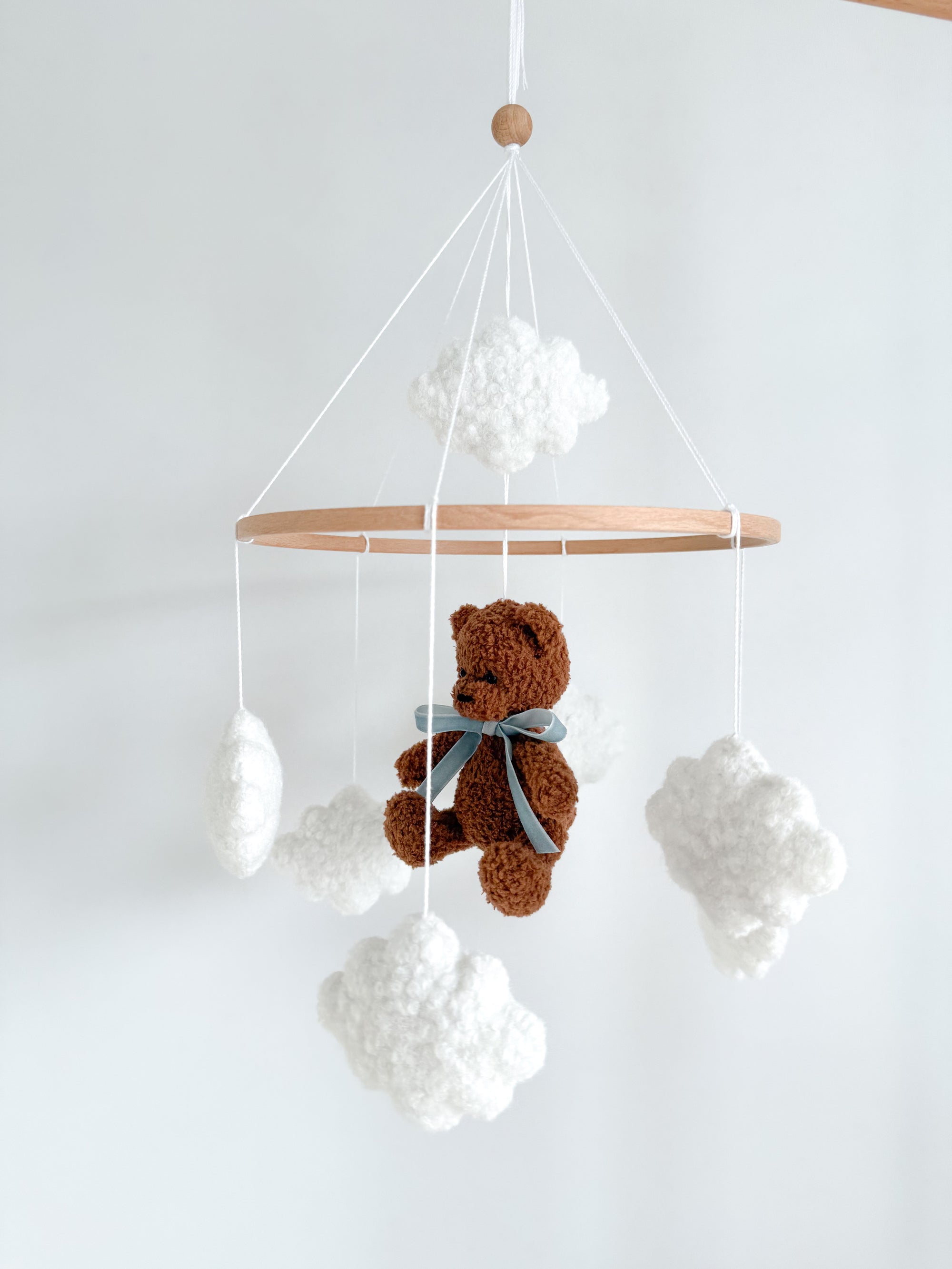 Boucle mobile with dark brown teddy bear