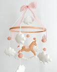 Mobile with a brown rocking horse and pink bow