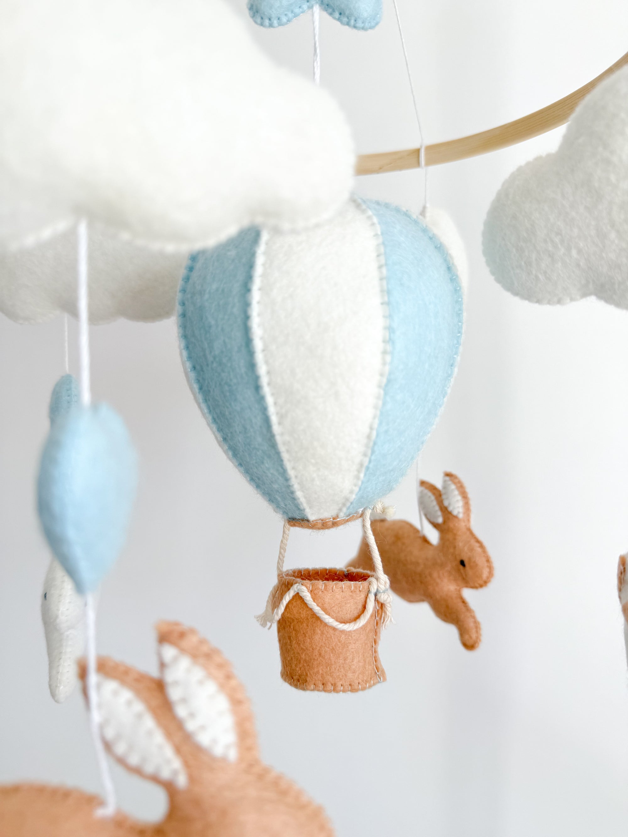 Brown bunny mobile with blue air ballon