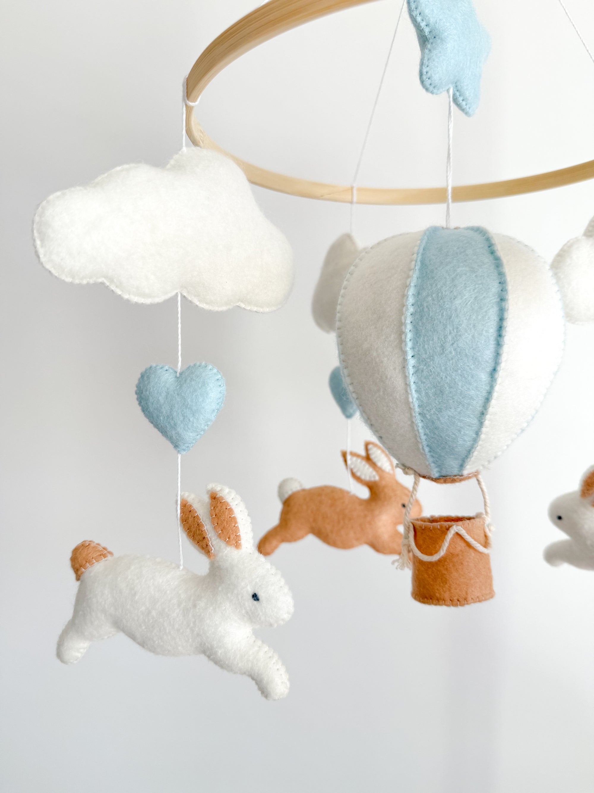 Brown bunny mobile with blue air ballon