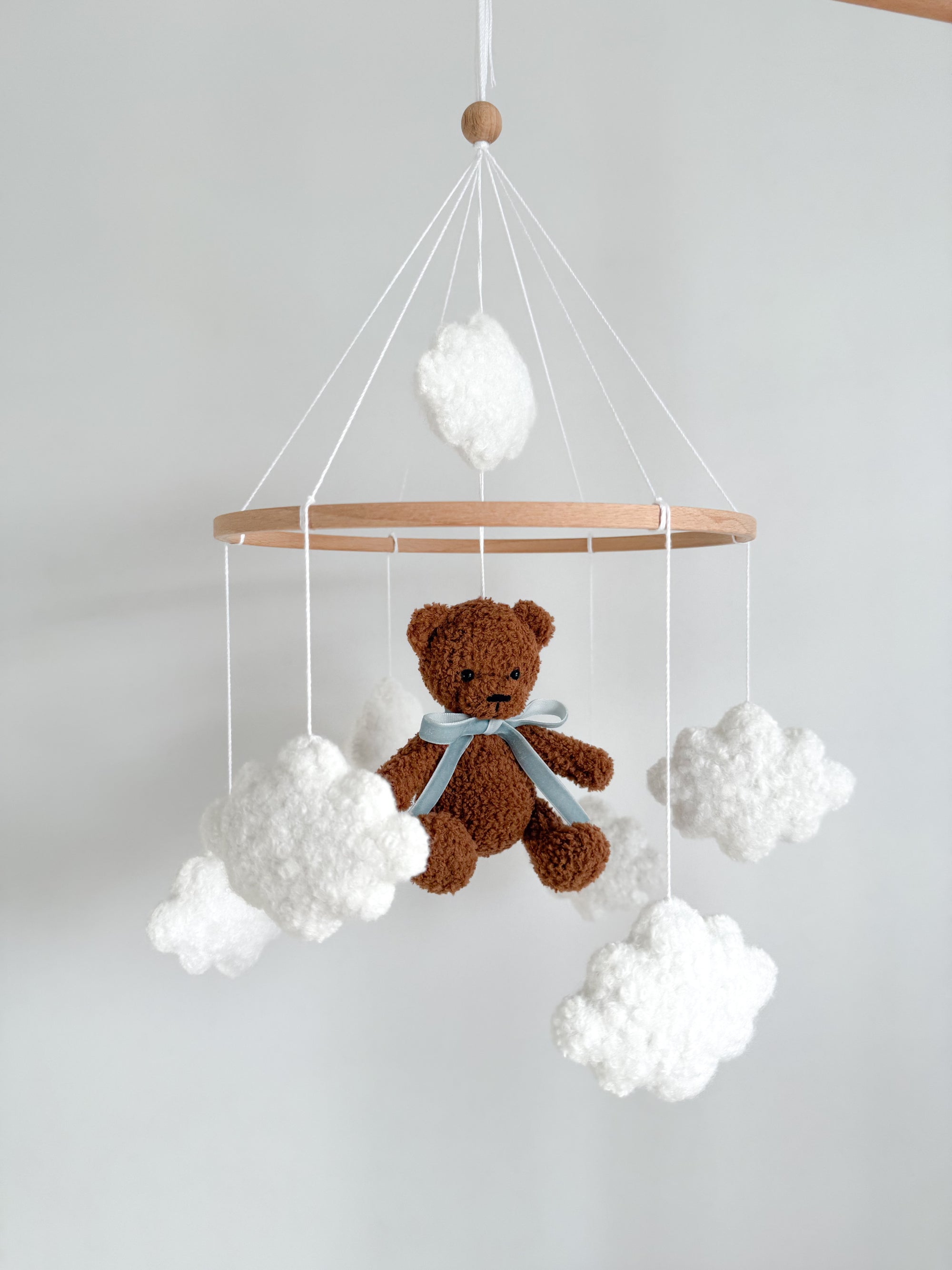 Boucle mobile with dark brown teddy bear