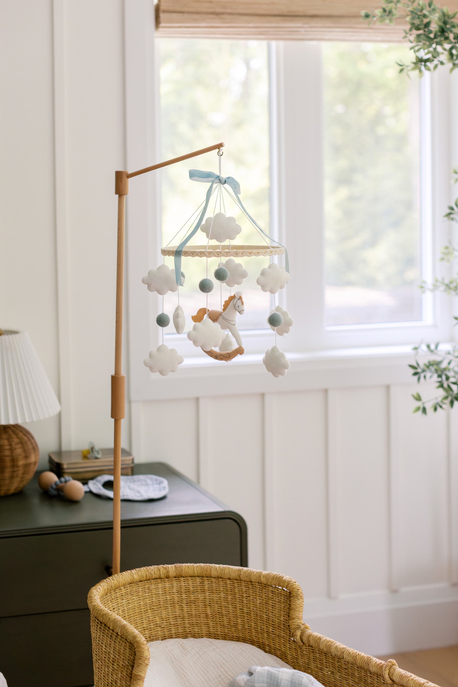 Mobile with a white rocking horse and a blue bow
