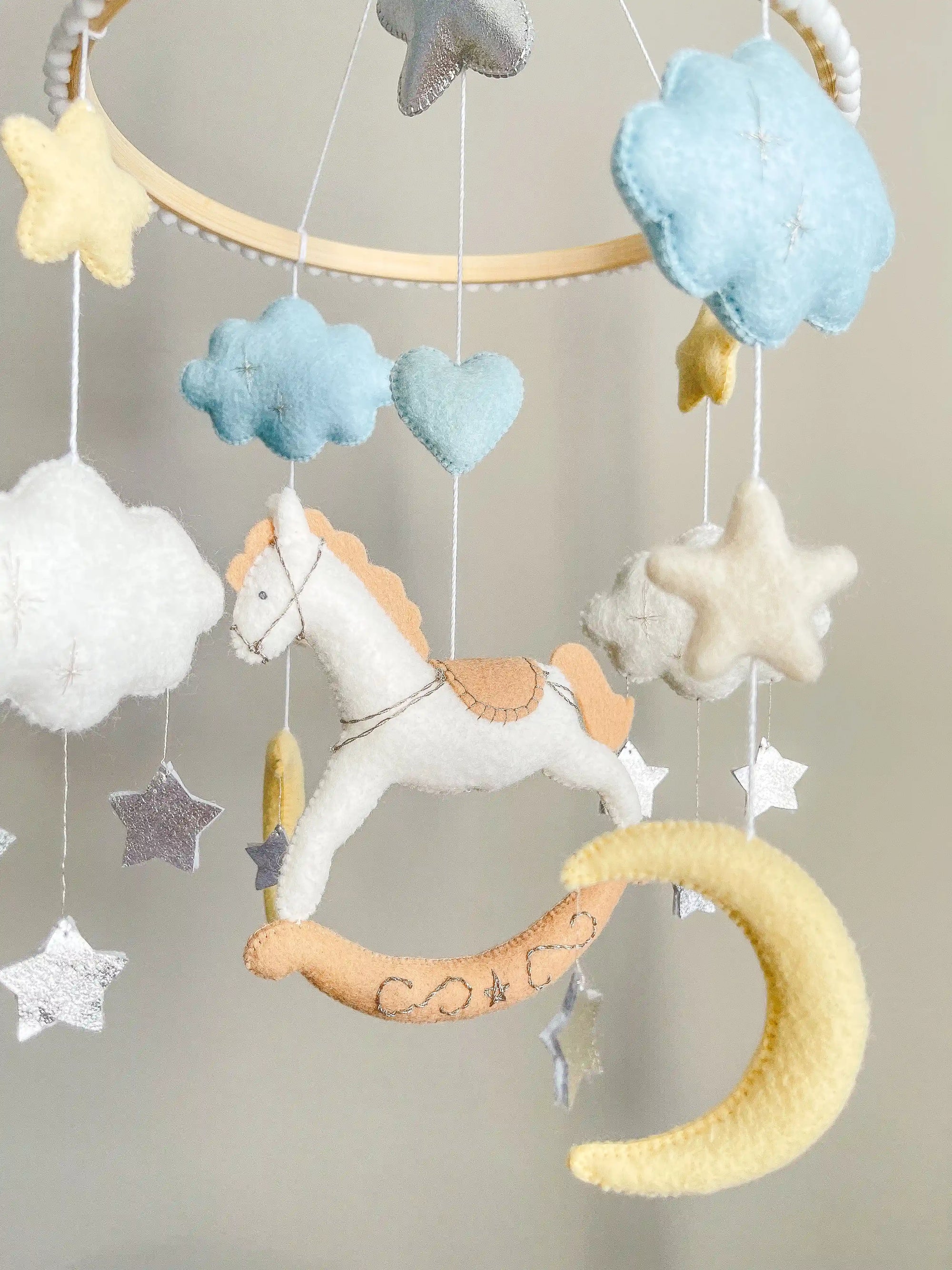 White rocking horse mobile with clouds
