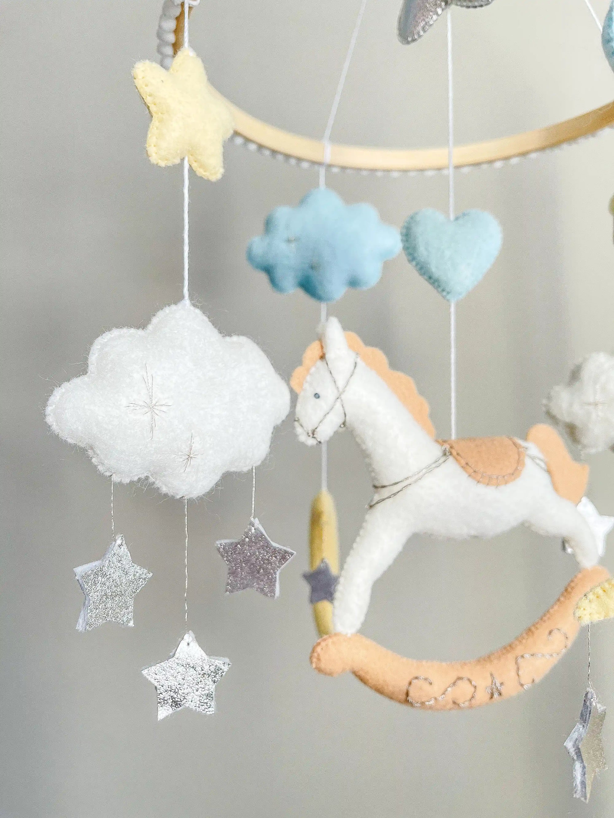 White rocking horse mobile with clouds
