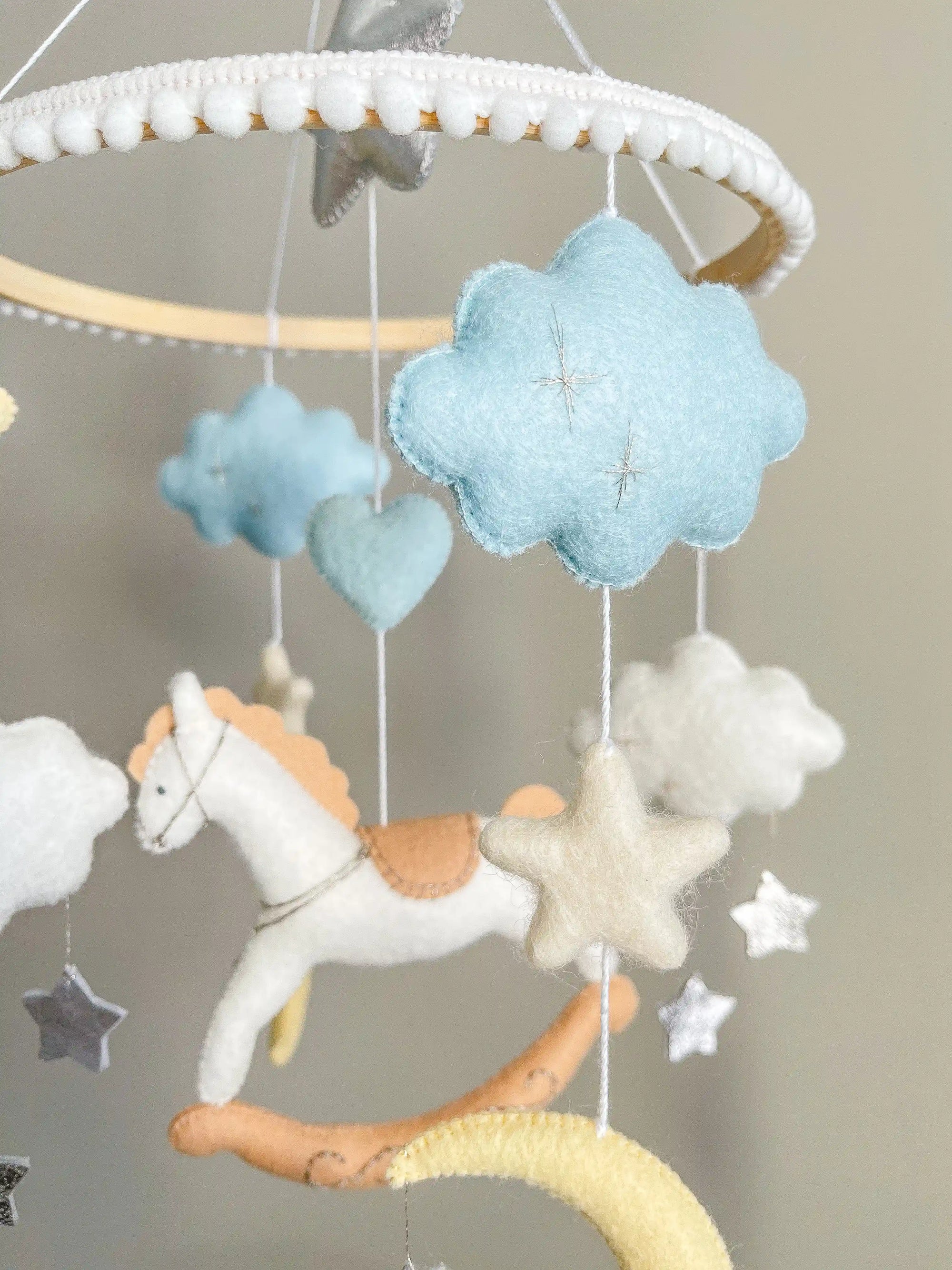 White rocking horse mobile with clouds