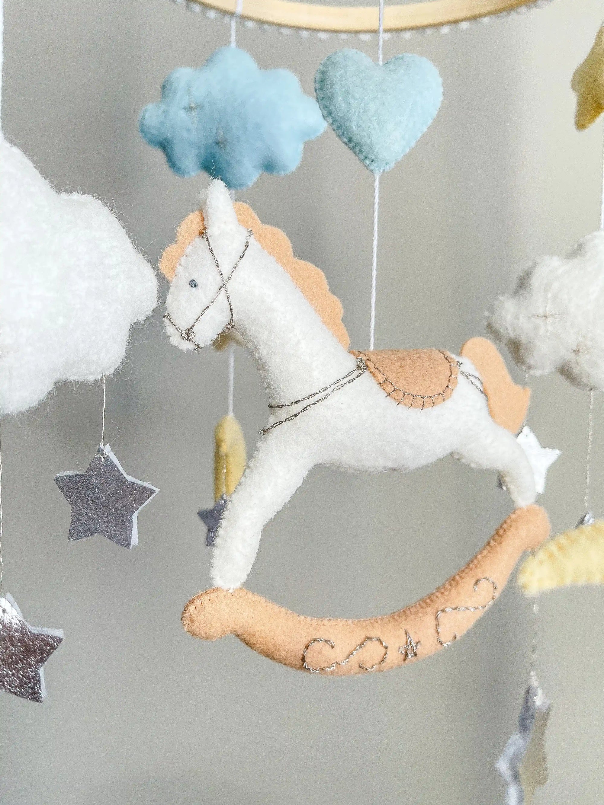 White rocking horse mobile with clouds