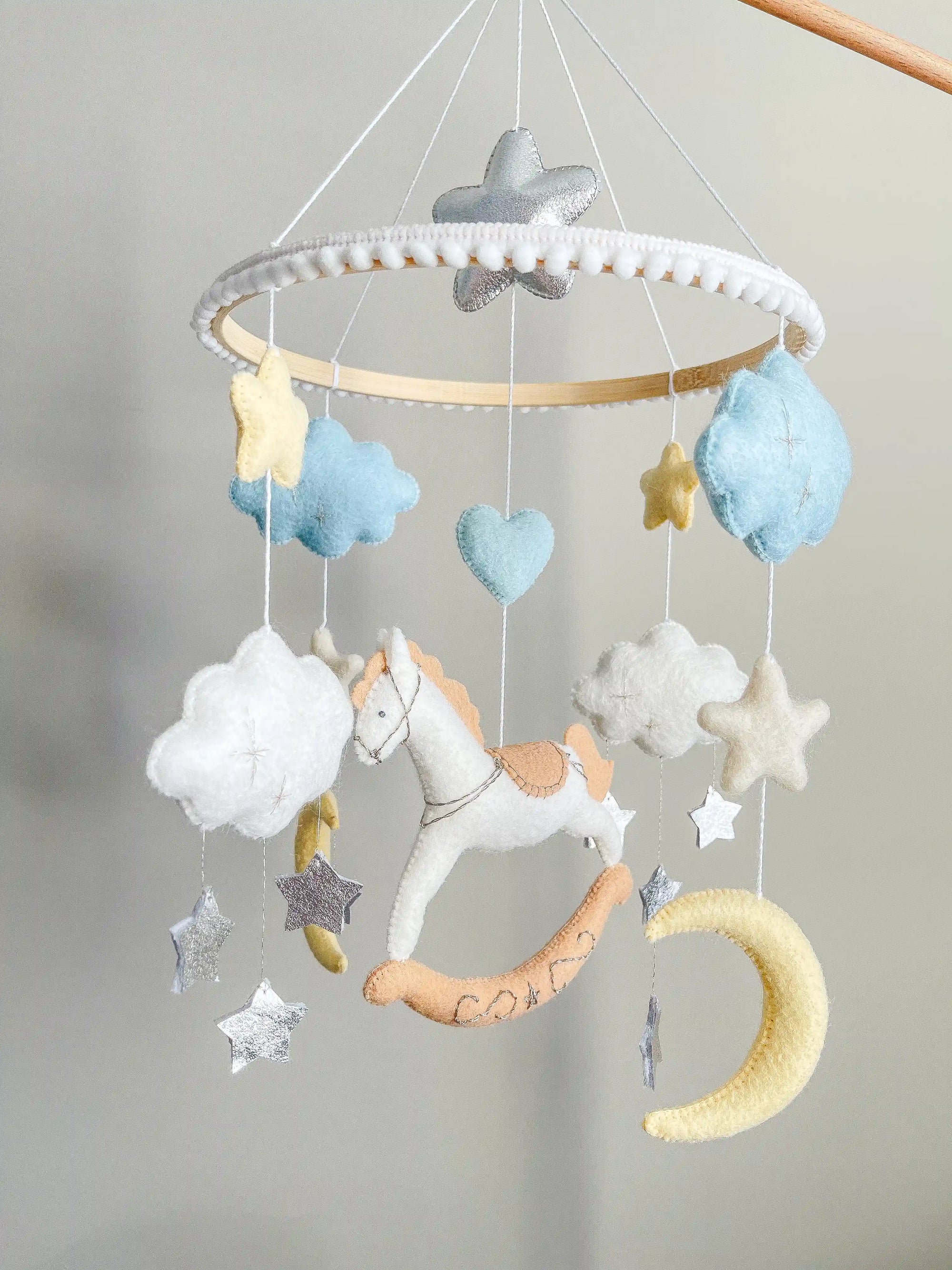 White rocking horse mobile with clouds
