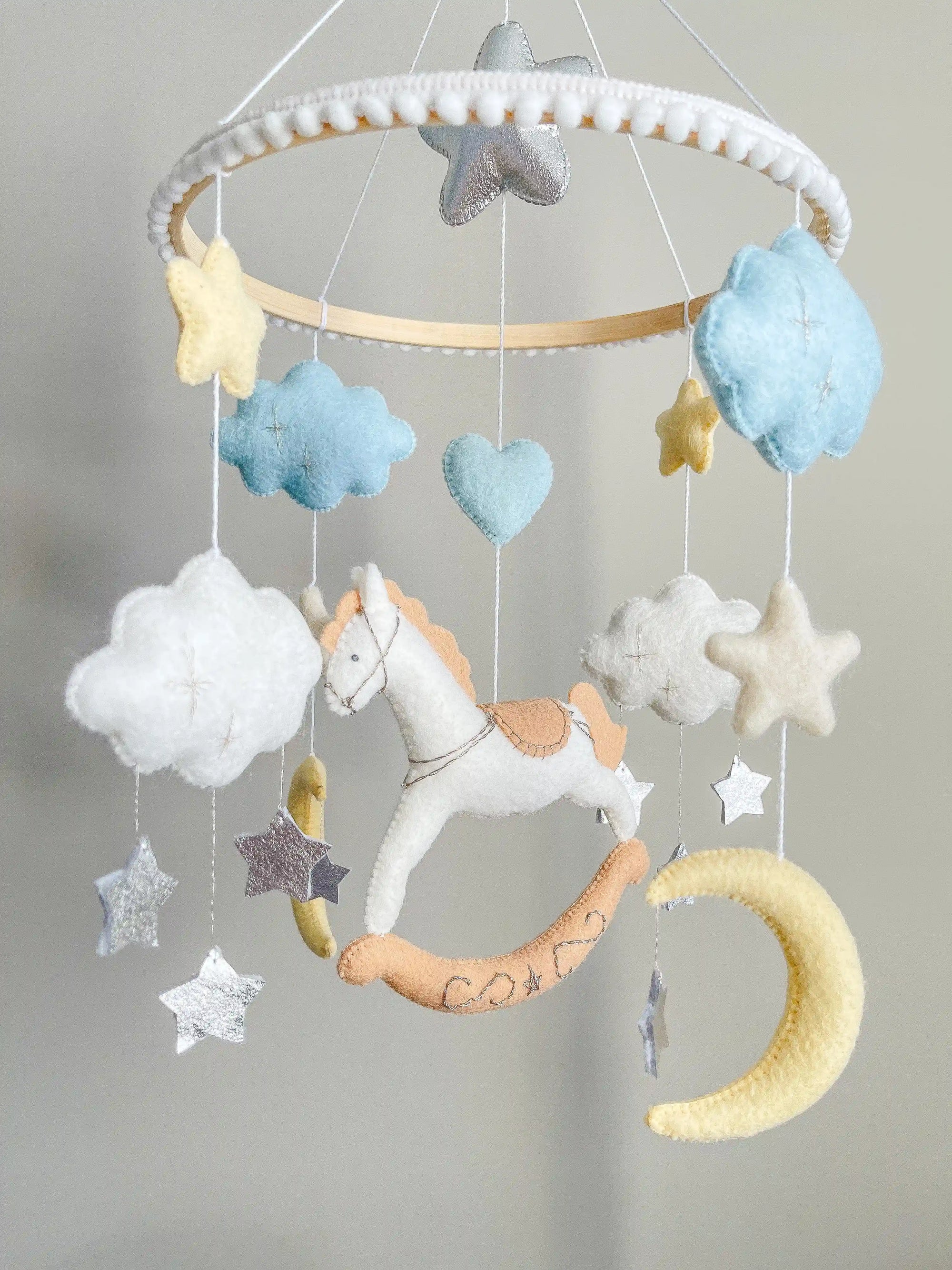 White rocking horse mobile with clouds