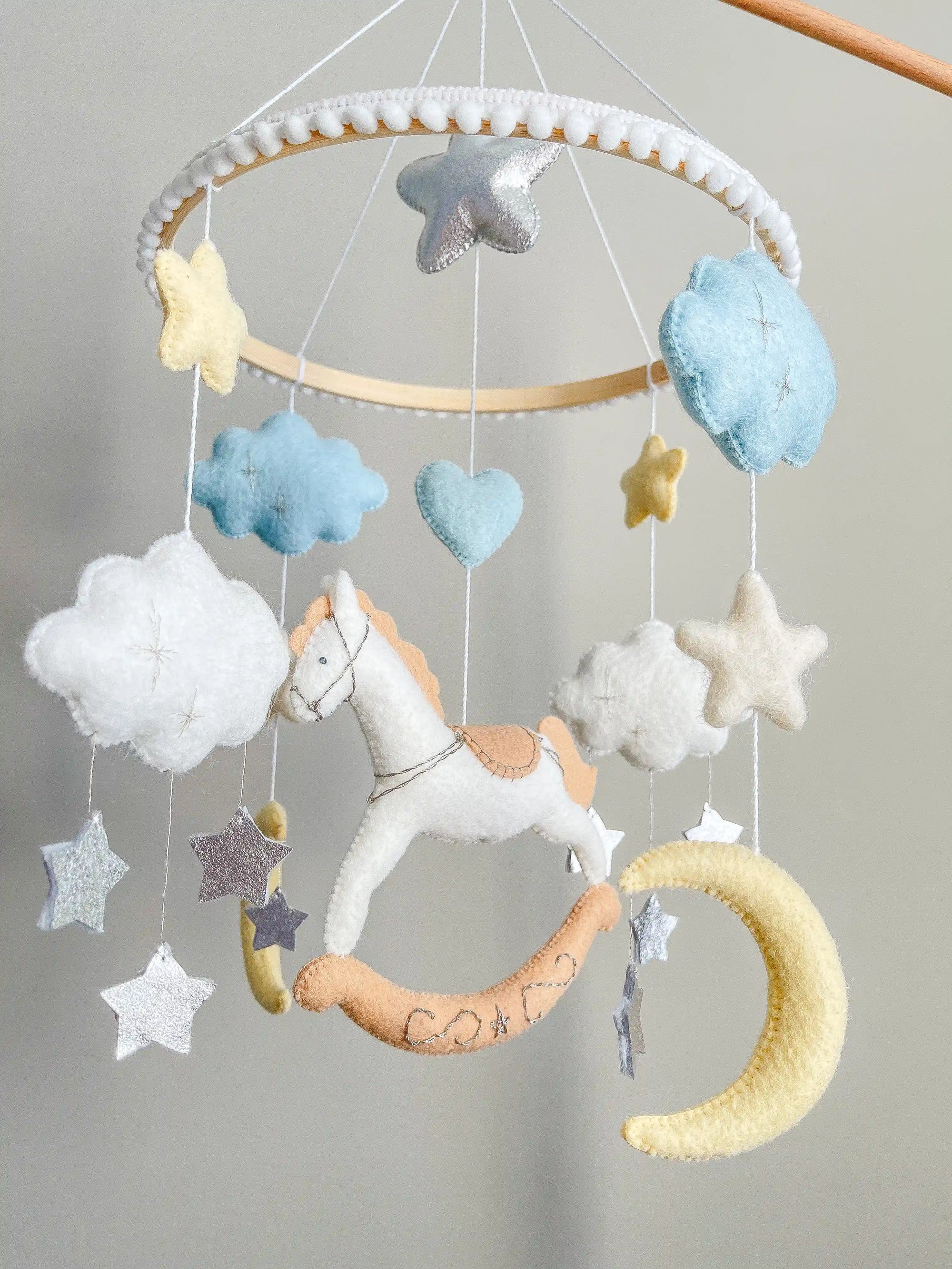 White rocking horse mobile with clouds