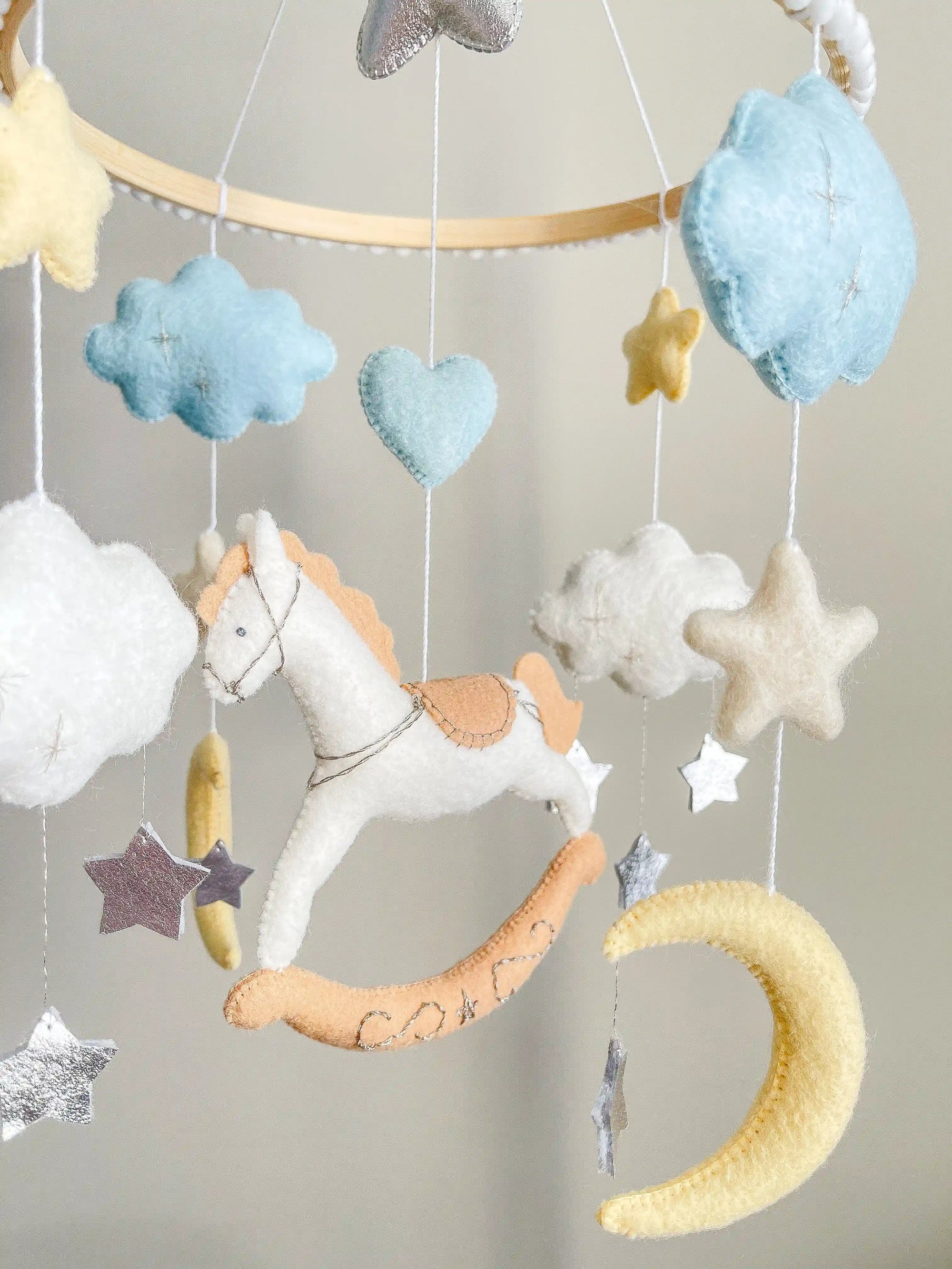 White rocking horse mobile with clouds