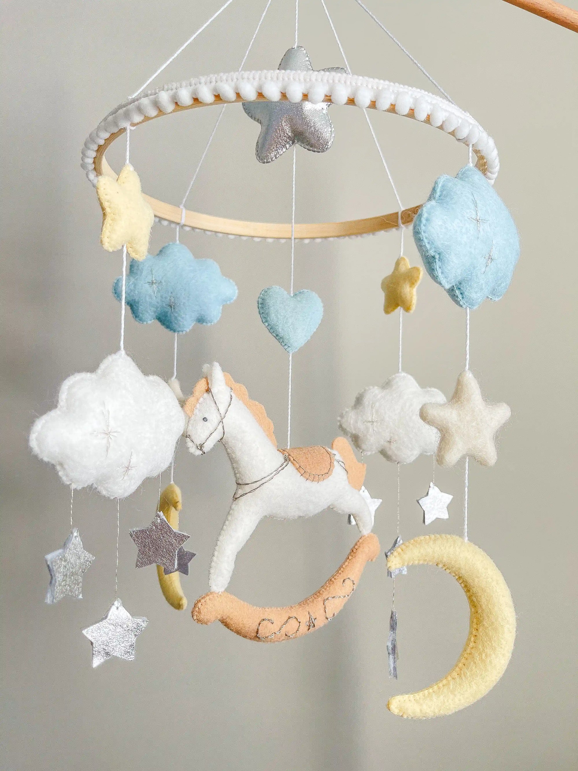 White rocking horse mobile with clouds