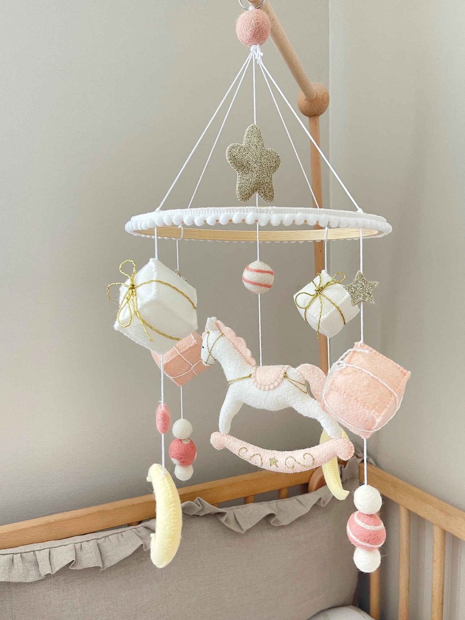 White rocking horse mobile with gifts