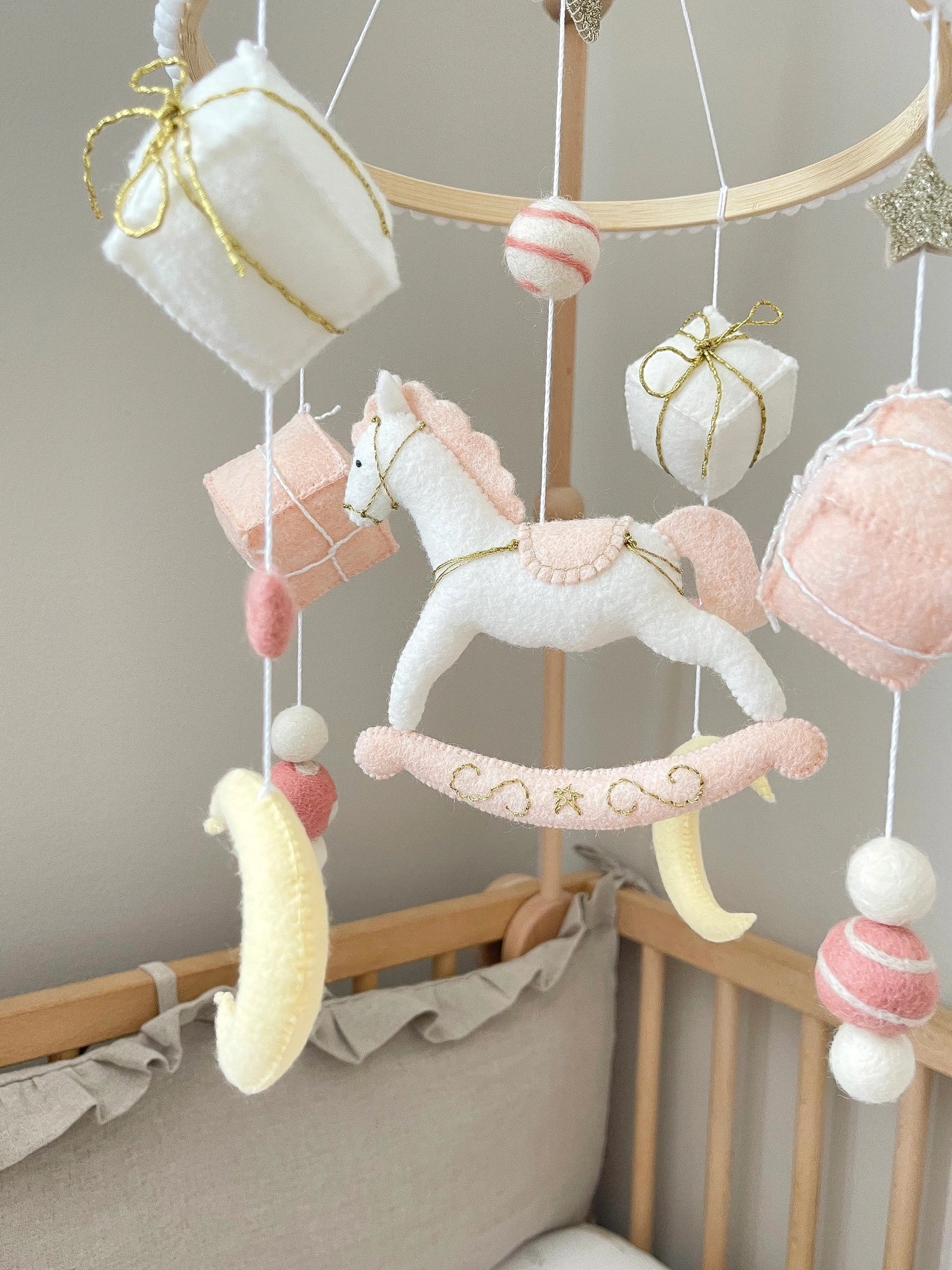 White rocking horse mobile with gifts