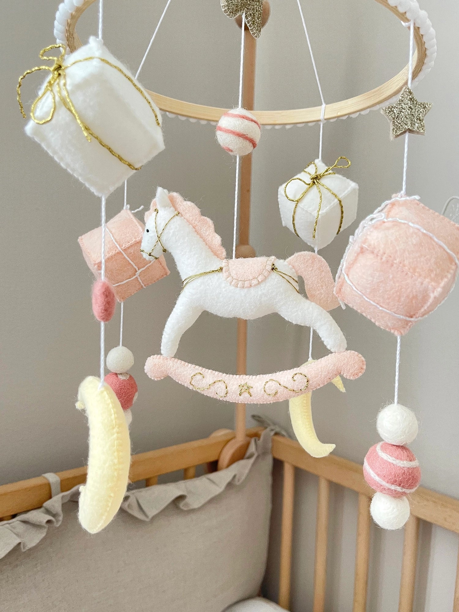 White rocking horse mobile with gifts