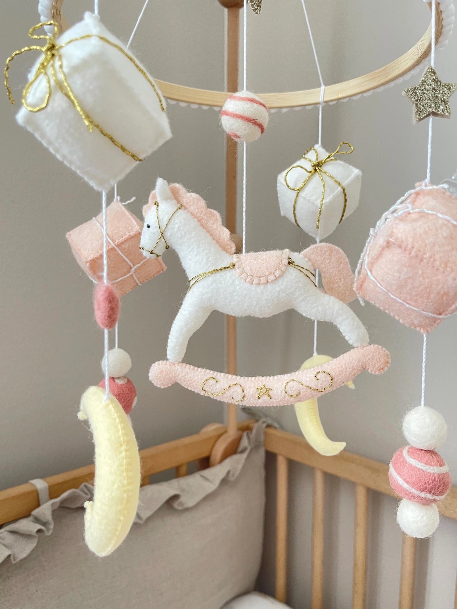White rocking horse mobile with gifts