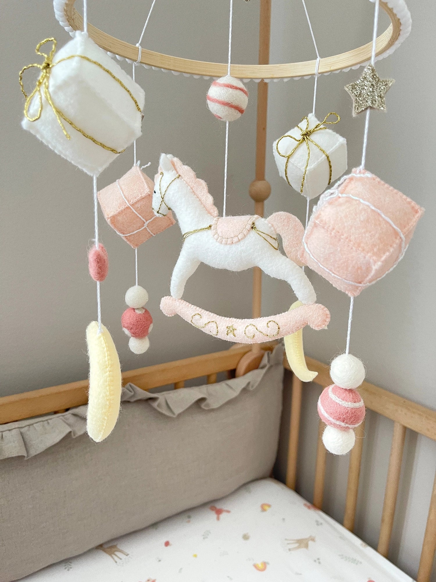 White rocking horse mobile with gifts