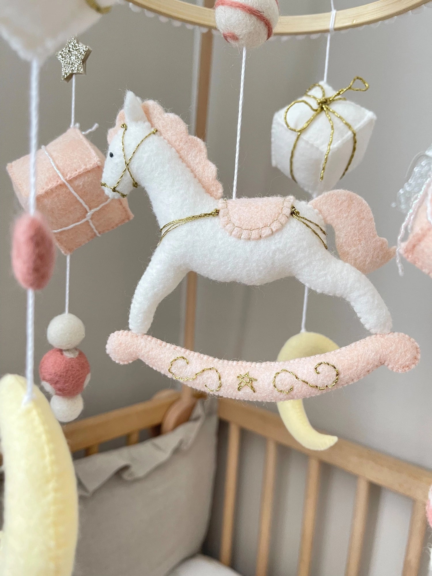 White rocking horse mobile with gifts