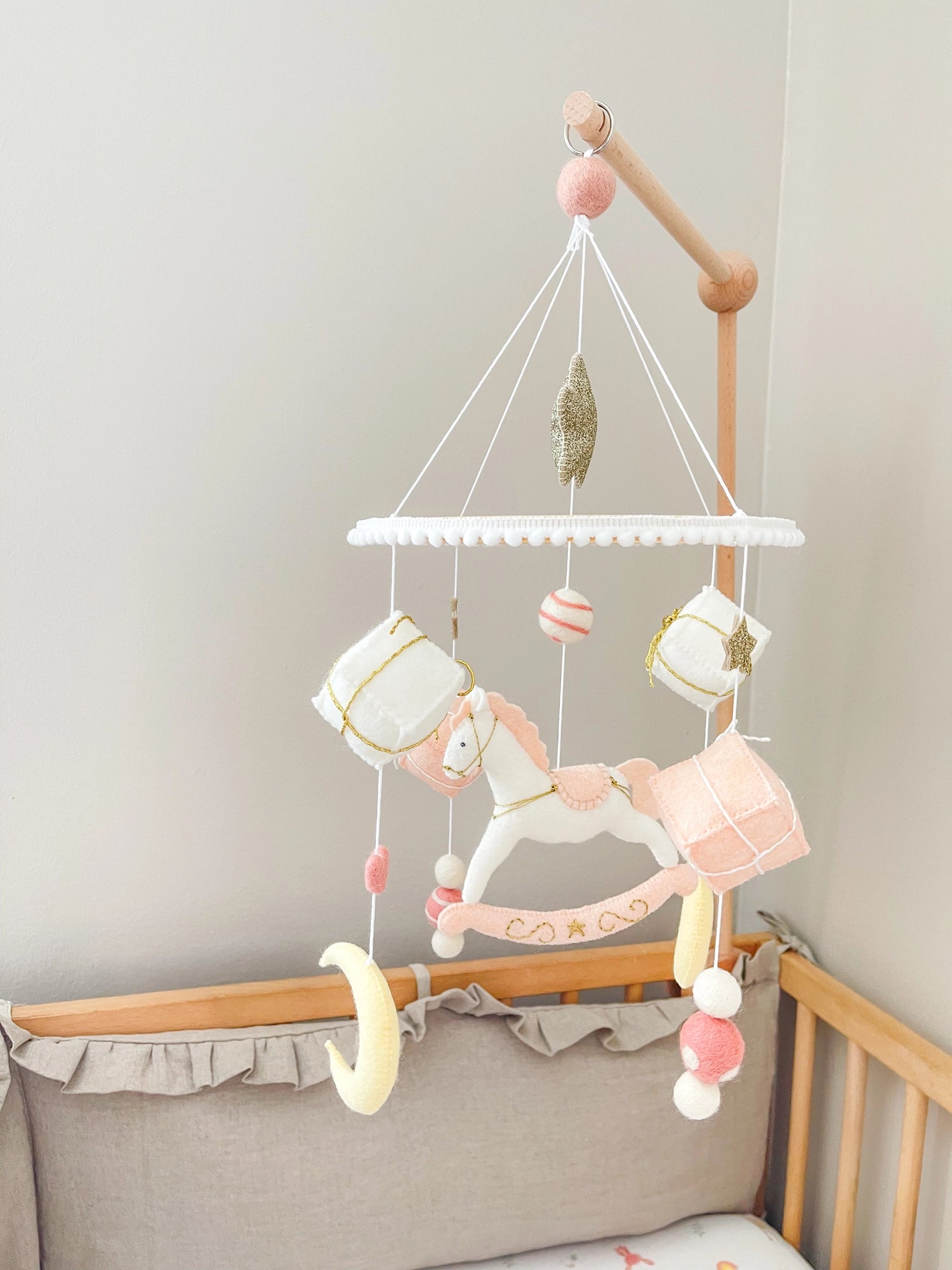 White rocking horse mobile with gifts