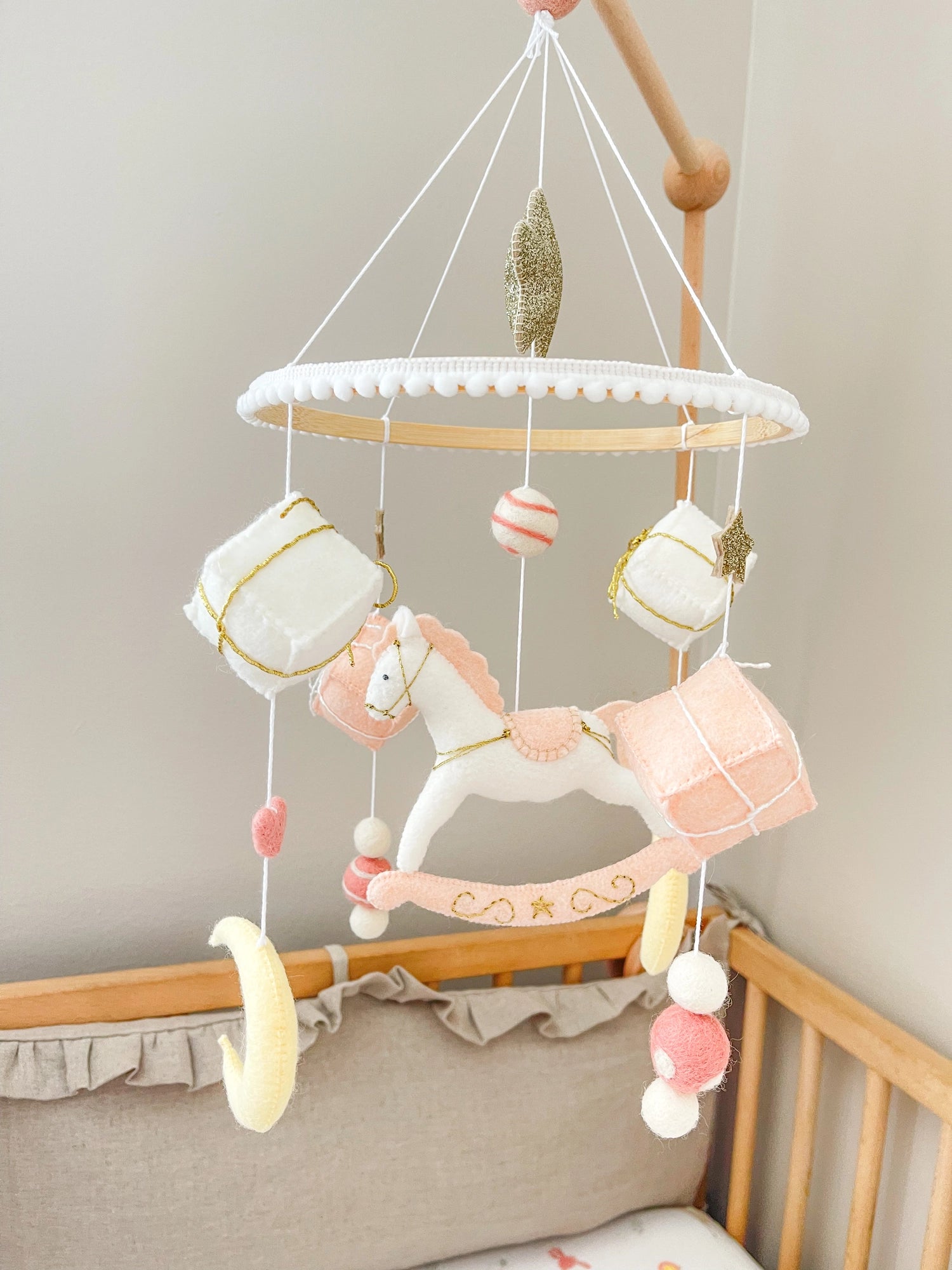 White rocking horse mobile with gifts