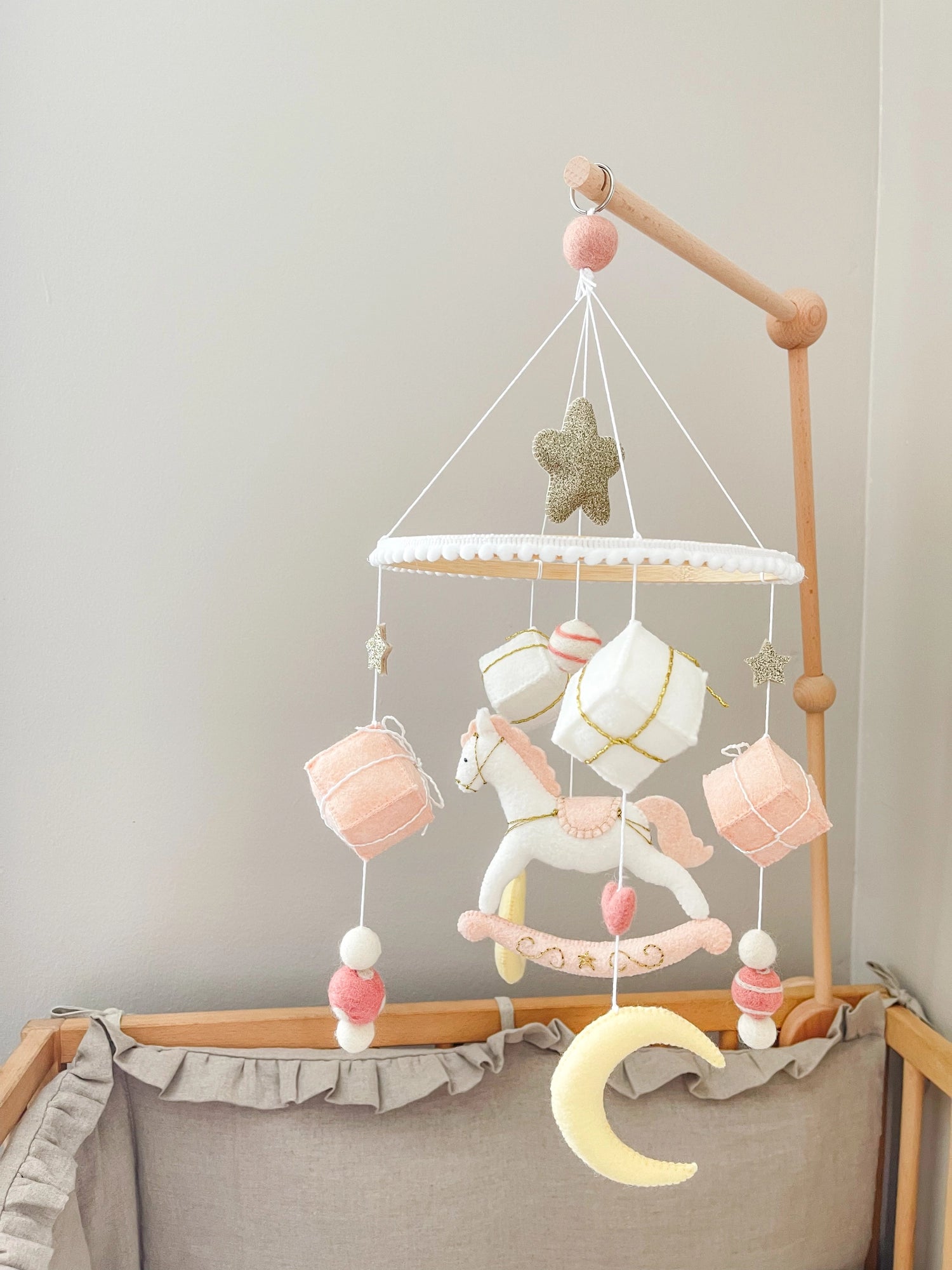 White rocking horse mobile with gifts