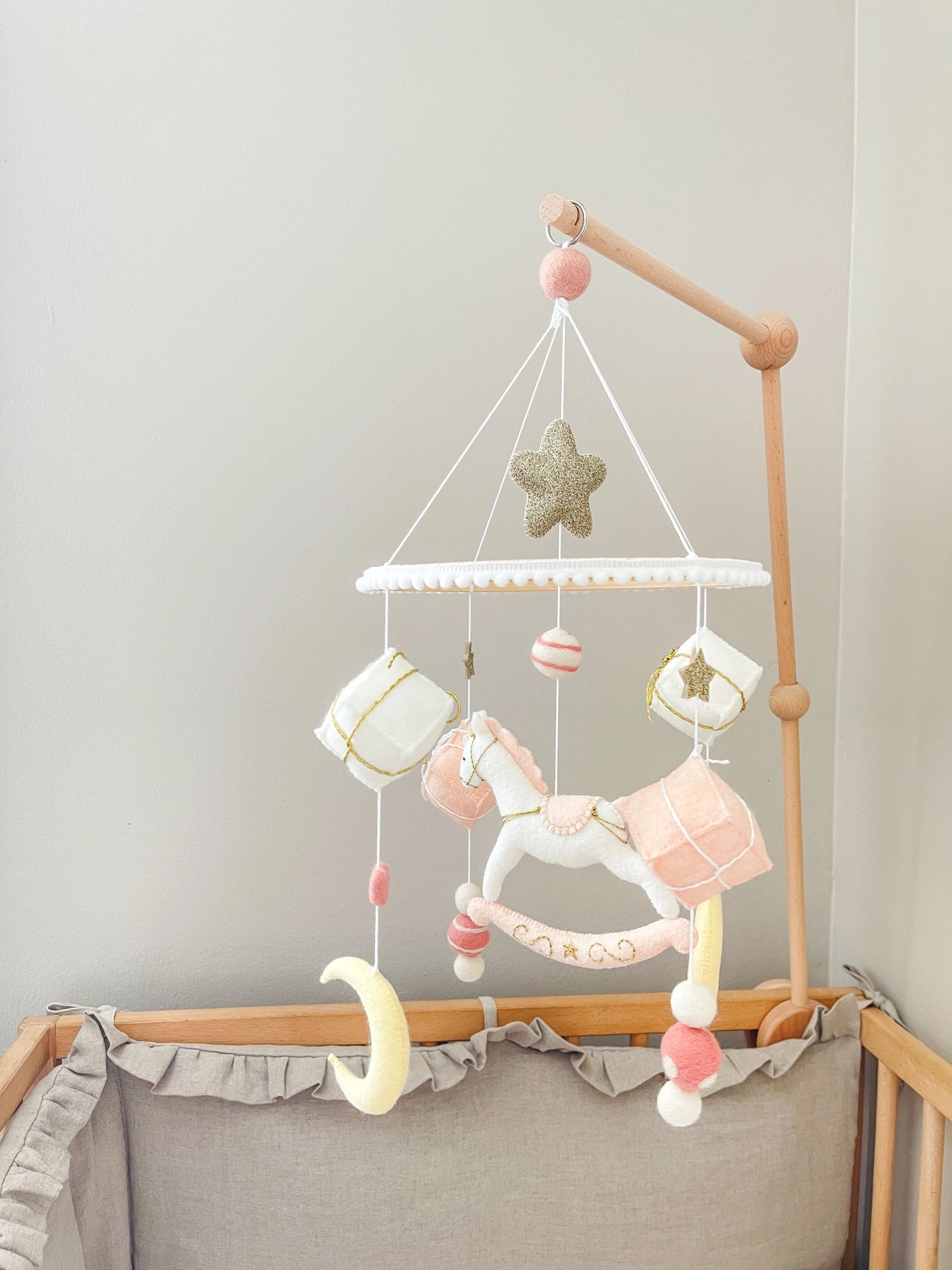 White rocking horse mobile with gifts