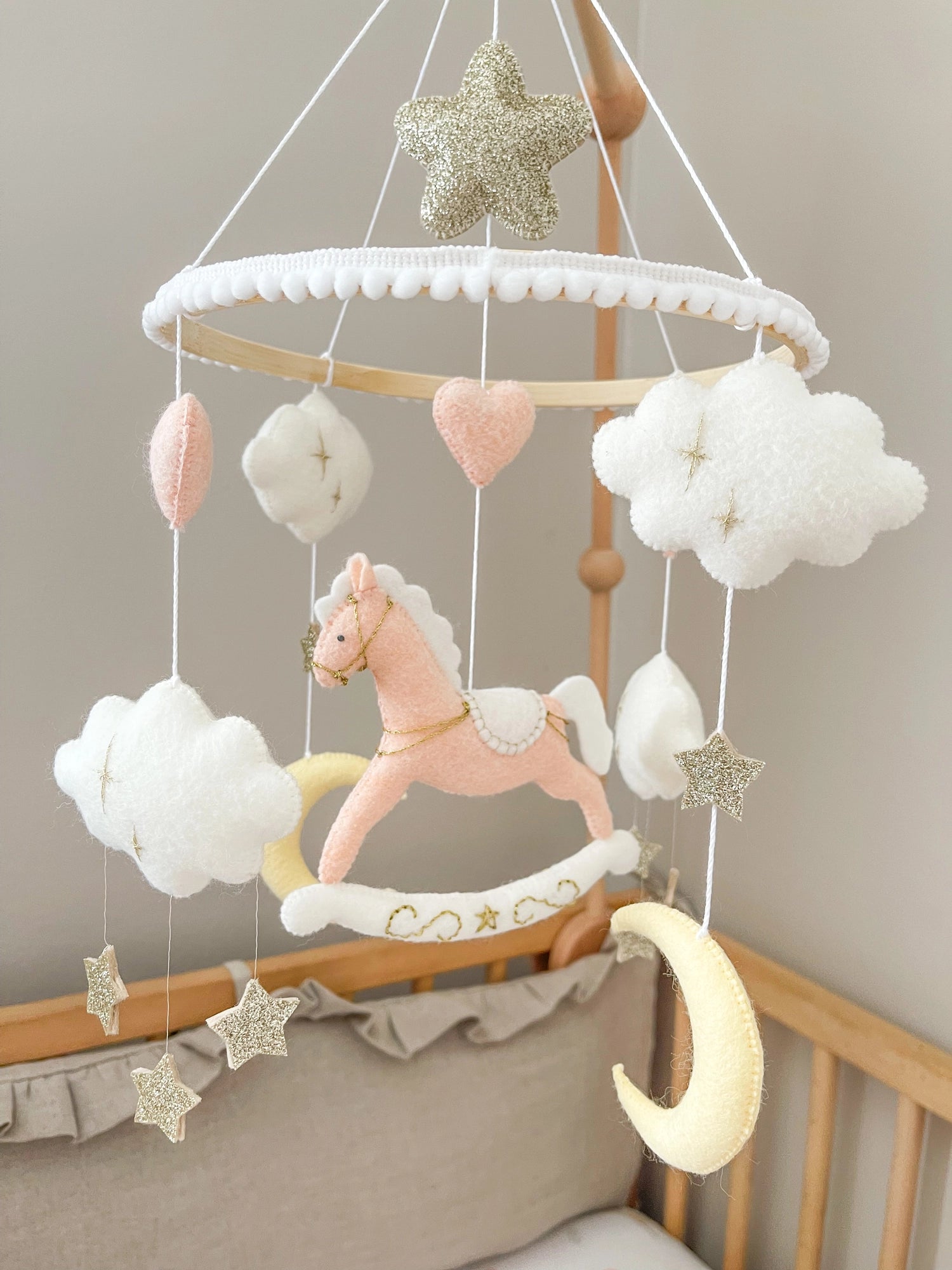 Pink rocking horse mobile with clouds