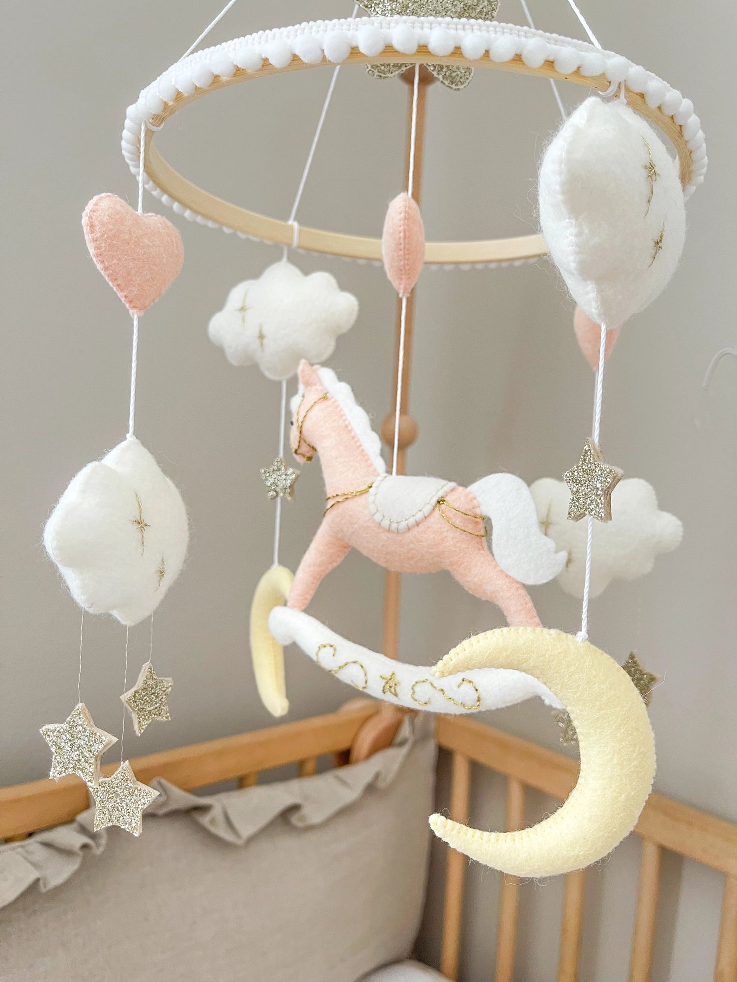 Pink rocking horse mobile with clouds